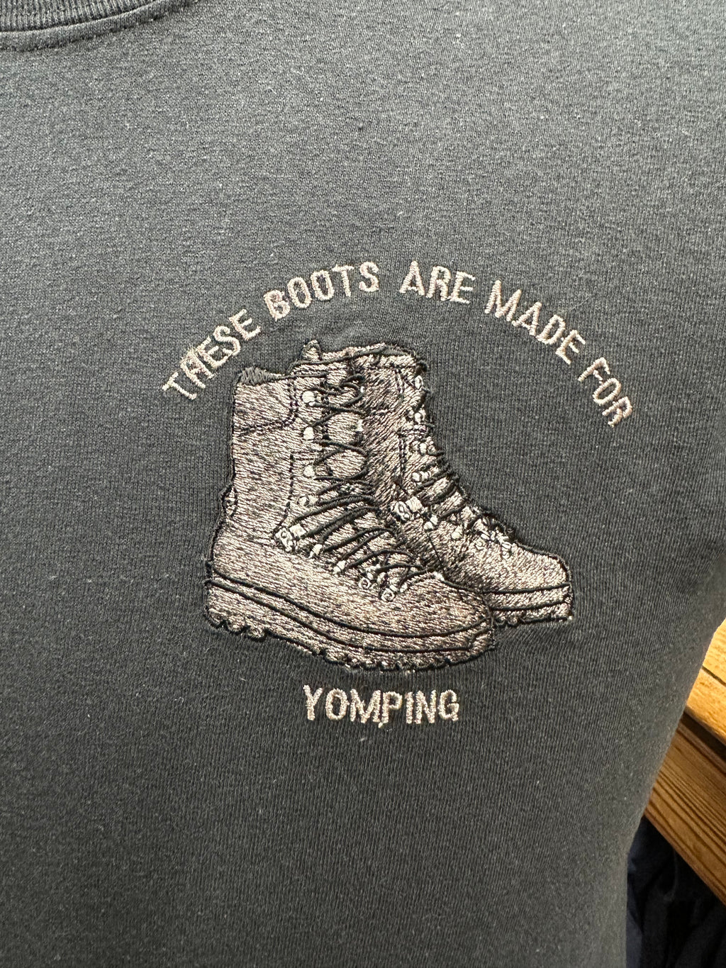 Black T-shirt with embroidered boots and text 