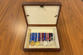 Set of medals in a wooden box on a wooden surface