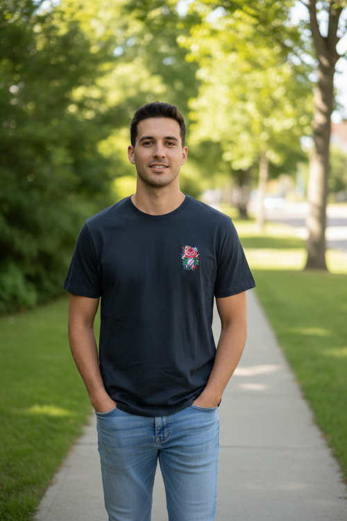 Man wearing a black t-shirt with a rose design outdoors on a sunny day