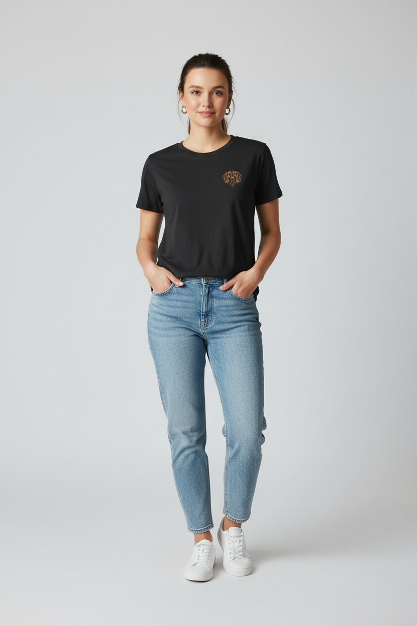 Person wearing a black t-shirt with a spaniel logo and light blue jeans on a white background