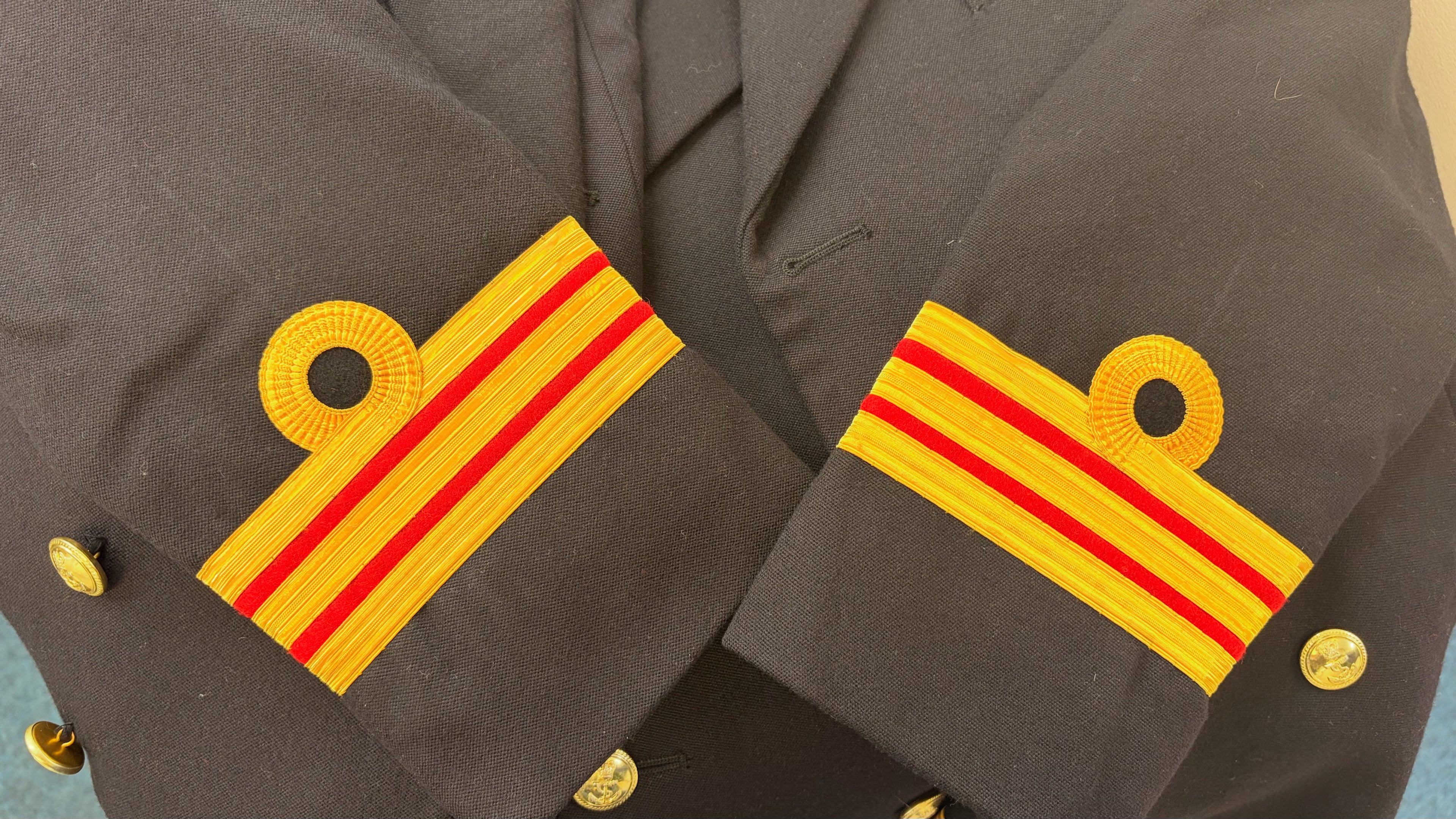 Close-up of a military uniform with Surgeon Commander Gold lace 