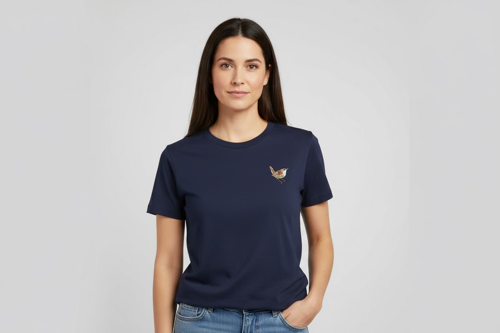 Woman wearing a navy blue t-shirt with a small logo on a light gray background
