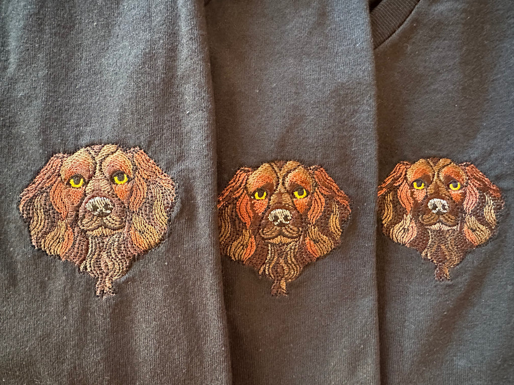 Three embroidered Spaniel faces on black t-shirts 