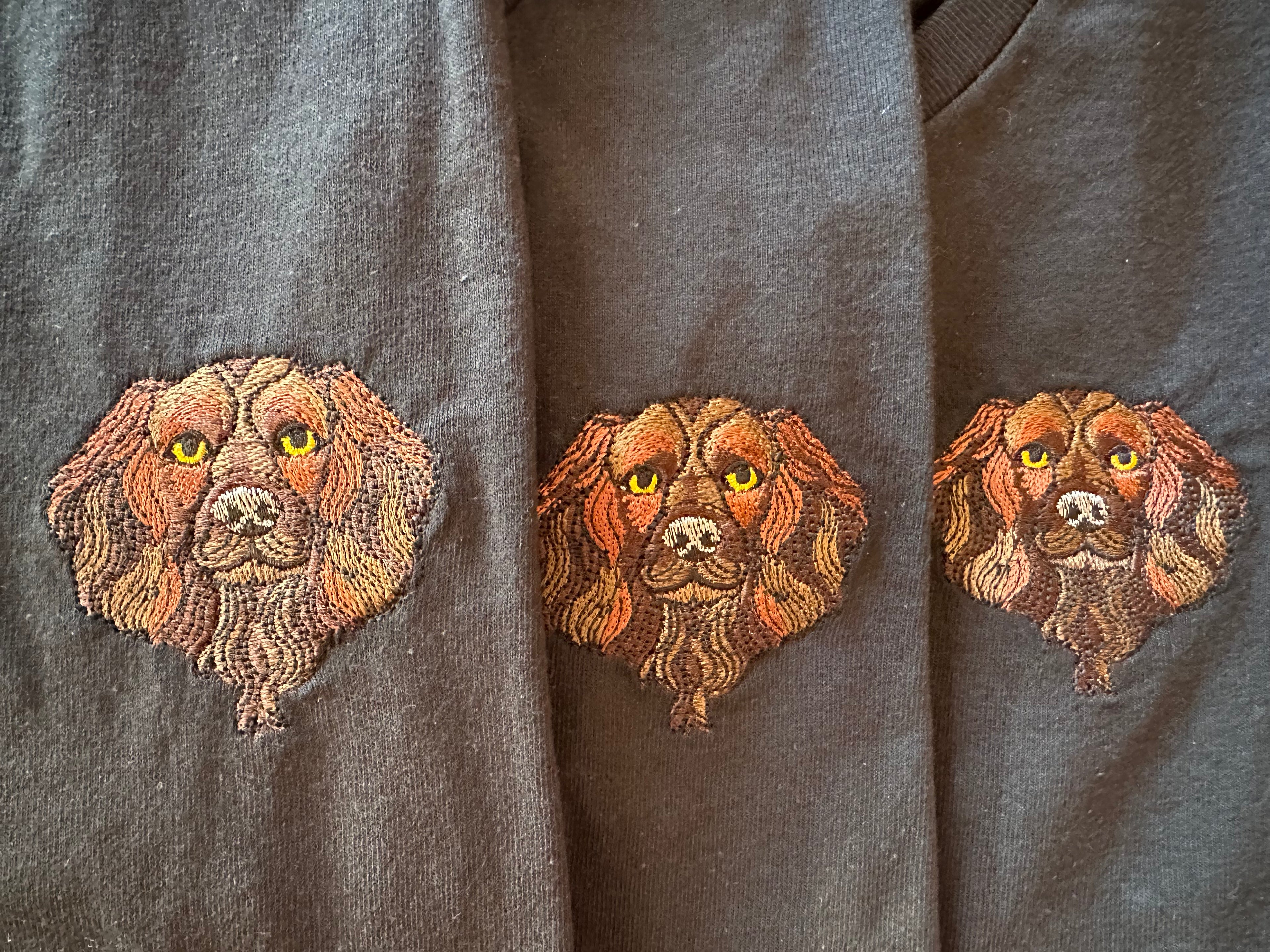 Three embroidered Spaniel faces on black t-shirts 
