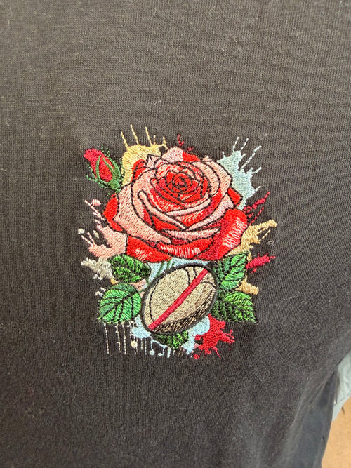 Embroidered rose design on a dark fabric background